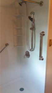 shower with chrome grab bars