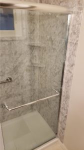 shower with single shelf with chrome roman block
