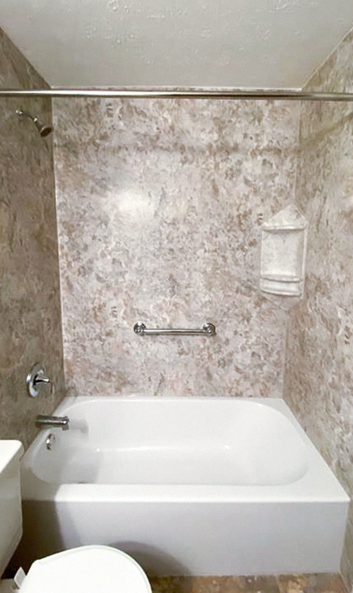 newly renovated half-bath with mottled brown marble backsplash