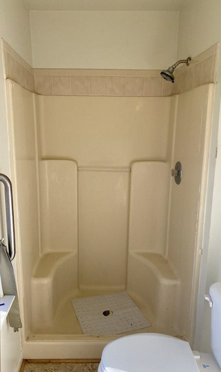 before photo of cream shower with little accessibility