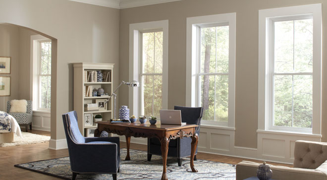 three large windows in an open-concept home office space