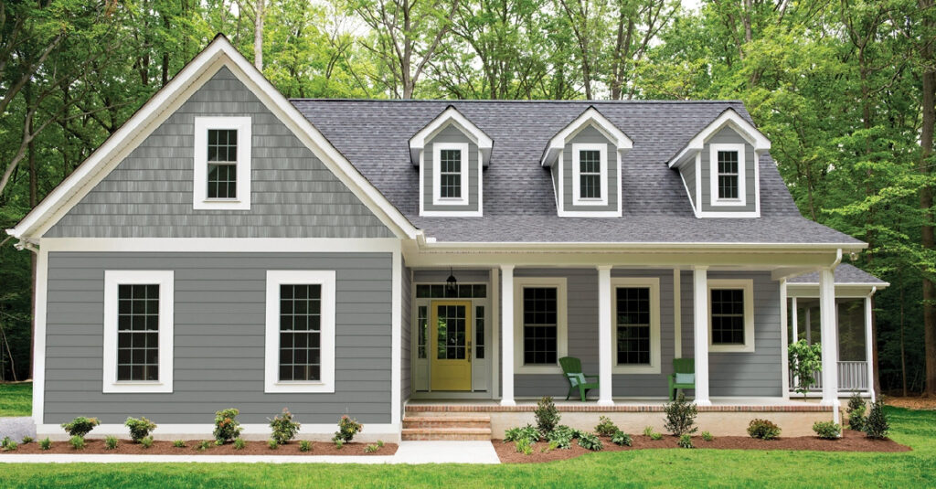 exterior of a large grey house with white trim