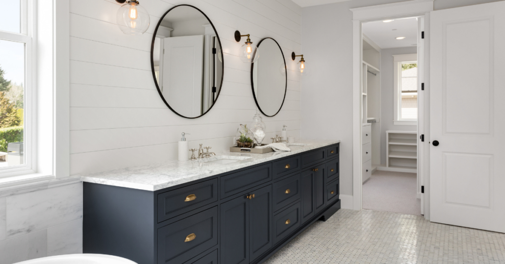 large luxury bathroom with large black vanities and mirrors