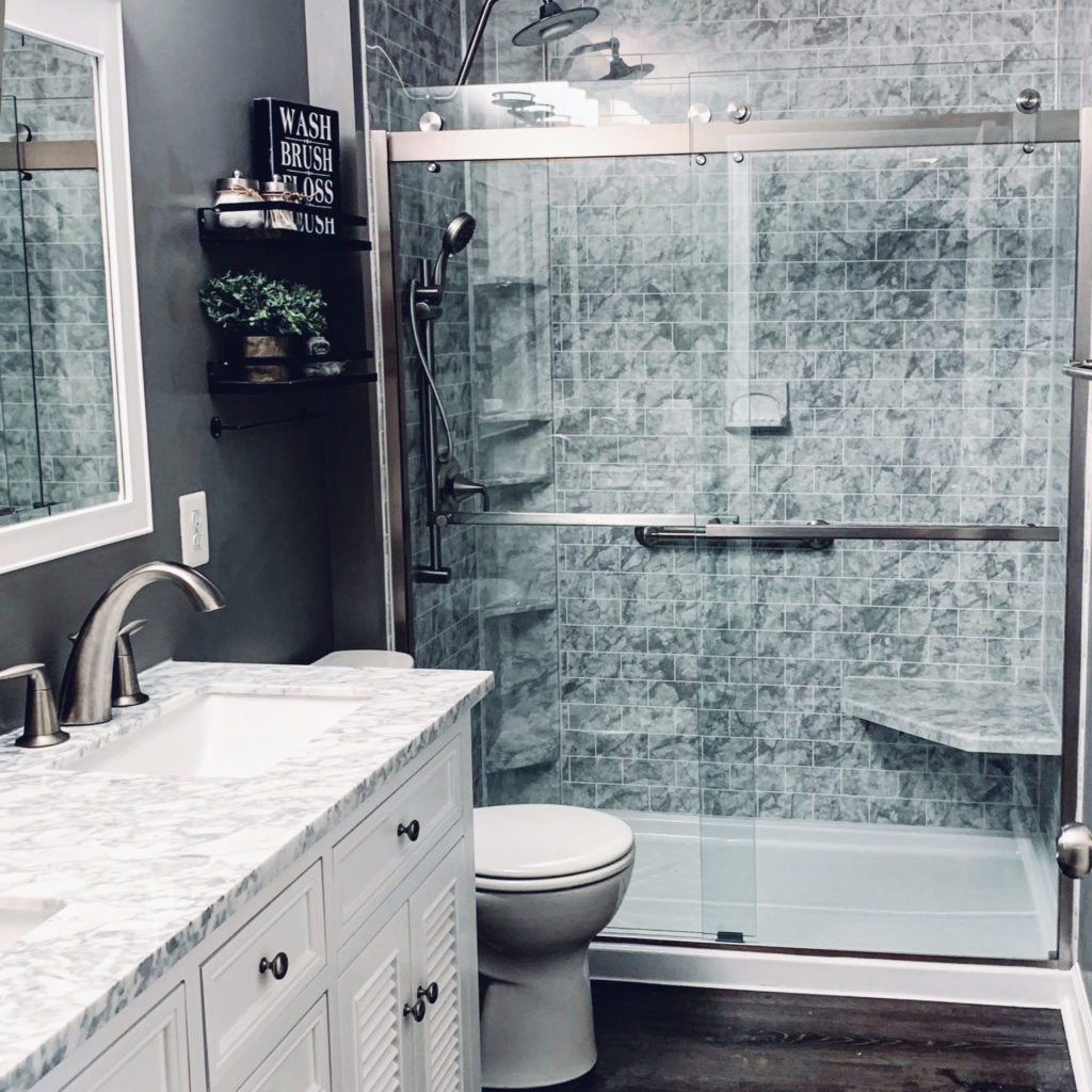 fresh shower remodel with marbled tiling