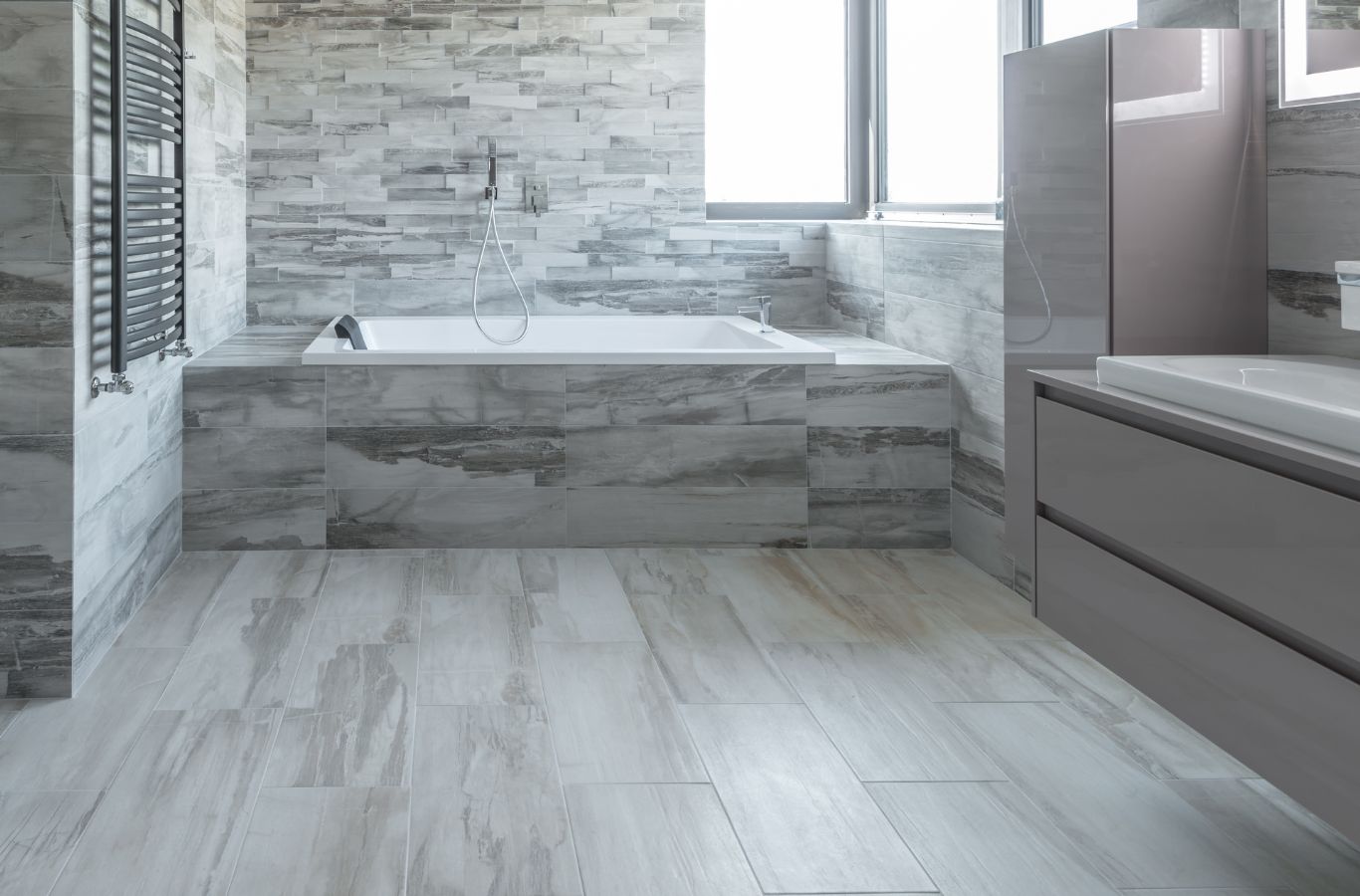 Benefits of Bathroom Remodeling in Colonial Heights, VA by Renken Remodeling A Renken Remodeling worker renovating a shower area in Colonial Heights, VA highlighting precise installation and design.